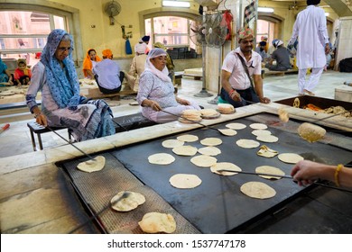 New Delhi / India - September 21, 2019: Volunteers preparing free food for visitors in the Gurdwara community kitchen (Langar hall) of Sri Bangla Sahib Gurudwara Sikh temple, New Delhi, India