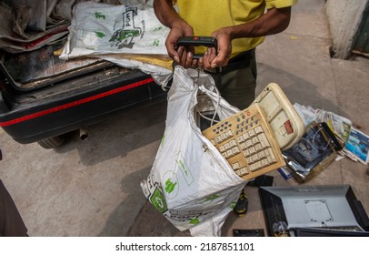 New Delhi, India-22 Sep 2016: Scrap Dealers Weighing Old Electronic Items From Local Resident,  Electronics Equipment For Recycling