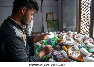 New Delhi, India-23 May 2022: Indian Worker Carrying Box Of Solar Lights, Solar Light Manufacturing Factory In Delhi, Solar Powered Light Manufacturing Factory.