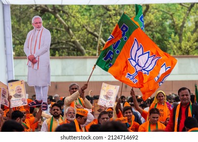 New Delhi, India-April 8 2019: Party Worker Flagged A Bharatiya Janata Party Flag During Release Of BJP Election Manifesto For The Upcoming Parliamentary Elections At Party Office.