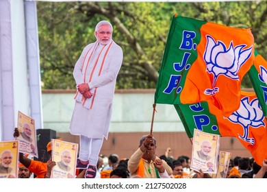 New Delhi, India-April 8 2019: Party Worker Flagged A Bharatiya Janata Party Flag During Release Of BJP Election Manifesto For The Upcoming Parliamentary Elections At Party Office.