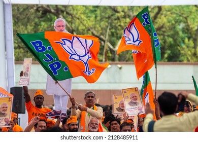 New Delhi, India-April 8 2019: Party Worker Flagged A Bharatiya Janata Party Flag During Release Of BJP Election Manifesto For The Upcoming Parliamentary Elections At Party Office.