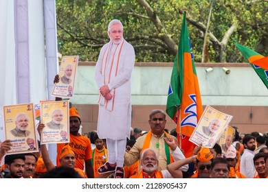 New Delhi, India-April 8 2019: Party Worker Flagged A Bharatiya Janata Party Flag During Release Of BJP Election Manifesto For The Upcoming Parliamentary Elections At Party Office.