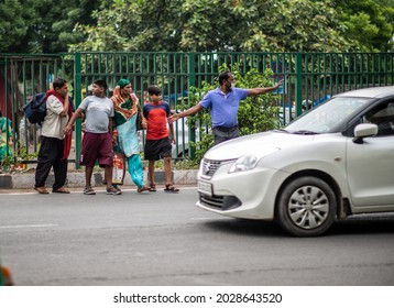 New Delhi, India-Aug 20 2021: People Crossing Road On Busy Traffic Near Bus Terminal Anand Vihar,  Breaking Rules People Crossing Road Illegally, They Are Not Using Foot Over Bridge.