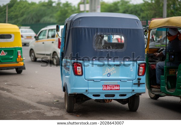 New Delhi, India-Aug 20\
2021: electric three wheeler on road of delhi, Piaggio Ape Electric\
Auto Rickshaw, Cargo 3 Wheeler\
piaggio ap e electric auto rickshaw\
on road.