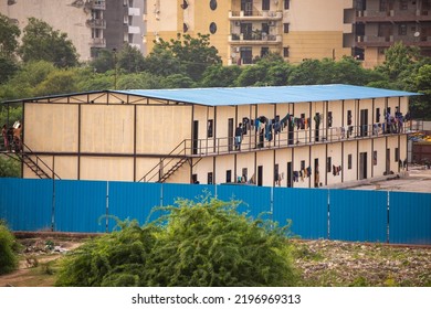 New Delhi, India-Aug 21 2022: A View Of Migrant Workers Clothes Hang From Balconies At Worker Housing Complex In Delhi,  Building Site Of Migrant Accommodation, Temporary House For Migrant Labor. 