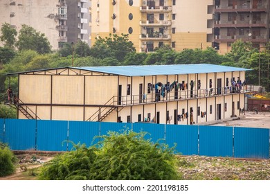 New Delhi, India-Aug 21 2022: A View Of Migrant Workers Clothes Hang From Balconies At Worker Housing Complex In Delhi,  Building Site Of Migrant Accommodation, Temporary House For Migrant Labor. 