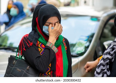 New Delhi, India-Aug 24 2021: Afghan woman crying during Protest outside at UNHCR, afghan family protesting and demanding to be given refugee status in India.