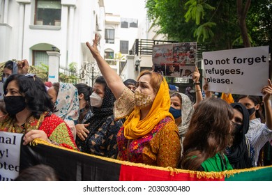 New Delhi, India-Aug 24 2021: Afghan woman shouting slogans with Hundreds of Afghans at UNHCR to protest against the Taliban takeover of Afghanistan and demanding to be given refugee status.