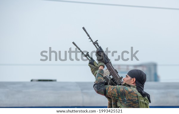 New Delhi, India-August 14 2019: RPSF commando\
firing on air showing combat skills during the launch of CORAS\
Commandos for Indian Railways special security force, New Delhi\
Railway station