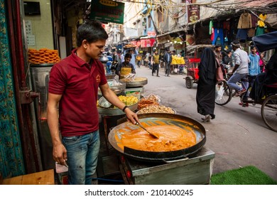 New Delhi, India-Dec 15 2021. A man preparing butter chicken curry at a StreetSide food shop in a jama masjid market. 