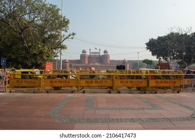 New Delhi, India-Dec 15 2021: Traffic Passing In Front Of Red Fort, Road Dividing With Police Barricading.