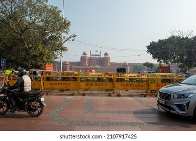 New Delhi, India-Dec 15 2021: Traffic Passing In Front Of Red Fort, Road Dividing With Police Barricading.