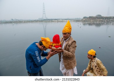 New Delhi, India-Feb 2 2022: Sindhi Hindus followers of Jhulelal holding worship items come at   yamuna river near kashmiri gate. for worship god varuna.