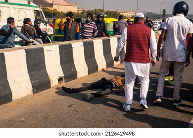 New Delhi, India-Feb 20 2022: Accident Victime Man Body Kept On Road, Car And Motorcycle Accident At Delhi Meerut Expressway Due To Overspeeding. Bike Rider Hit By A Overspeed Car. People Helping 