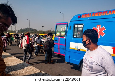 New Delhi, India-Feb 20 2022: bike rider hit by a overspeed car at Delhi Meerut expressway.  people helping to road accident victim sending to hospital by NHAI ambulance near akshardham temple