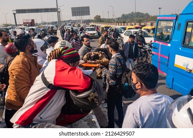 New Delhi, India-Feb 20 2022: Bike Rider Hit By A Overspeed Car At Delhi Meerut Expressway.  People Helping To Road Accident Victim Sending To Hospital By NHAI Ambulance Near Akshardham Temple