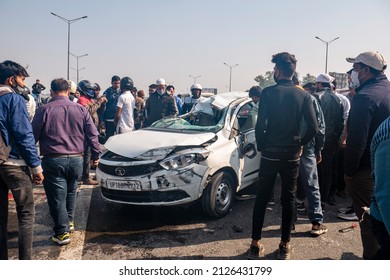 New Delhi, India-Feb 20 2022: Damaged Tata Car On Road After Car And Motorcycle Accident At Delhi Meerut Expressway Due To Overspeeding. People Helping To Road Accident Victims