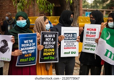 New Delhi, India-Feb 9 2022: Muslim Student Federation (MSF) member holds a placard as she participates in a protest against the recent hijab ban in some high schools and colleges of Karnataka