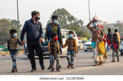 New Delhi, India-Jan 26 2022: Middle Class Family In Mask Member Walking On Road