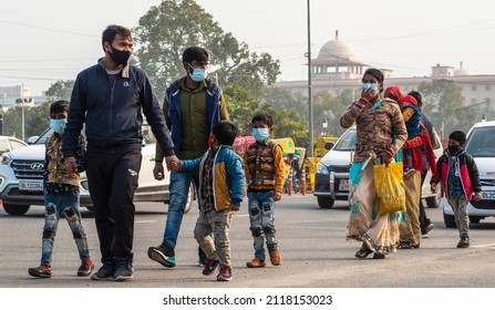 New Delhi, India-Jan 26 2022: Middle Class Family In Mask Member Walking On Road