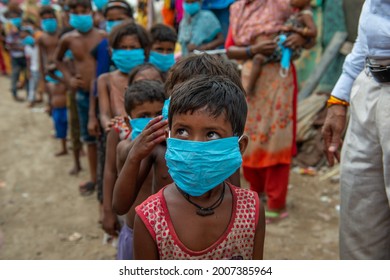 New Delhi, India-July 11 2021: Poor Children In Face Mask  During Covid Awareness Campaign At Slum Area Near New Usmanpur In New Delhi, In India Almost 385 Million Children Living In Extreme Poverty.