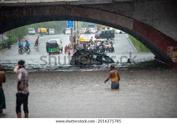 New Delhi, India-July 13\
2019: A DTC bus and fortuner car almost submerged at waterlogged\
Minto Bridge underpass after rains in New Delhi Monsoon arrives in\
Delhi