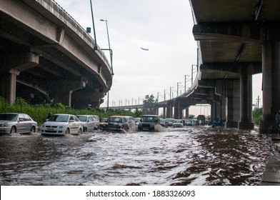 New Delhi, India-July 8 2019: Vehicles Making Its Way On A Flooded Road After Heavy Rains Near Delhi Dogmatic Airport.