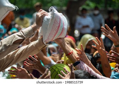 New Delhi, India-June 5 2021: Sack Of Flour Women Arm Raise For Catch The Flour Sack During Free Food Distribution Event  At G B Road For Sex Workers; 