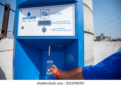 New Delhi, India-March 25, 2014: Man Using Pre Paid Card At Sarvajal Water ATM At Jhuggi Jhopri Colony, New Delhi, The Water ATMs In The Colony Are Operated By A Pre Paid Card. Filling Drinking Water.