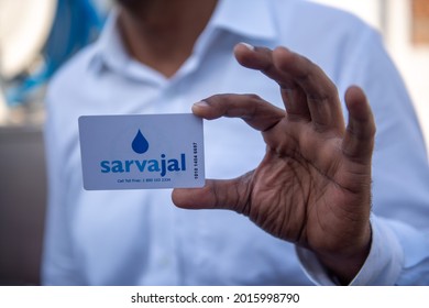 New Delhi, India-March 25, 2014: Man Showing Sarvajal Water ATM Card In Jhuggi Jhopri Colony In New Delhi, The Water ATMs In The Colony Are Operated By A Pre Paid Card That Can Be Topped 