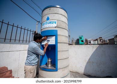 New Delhi, India-March 25, 2014: Man Using Pre Paid Card At Sarvajal Water ATM At Jhuggi Jhopri Colony, New Delhi, The Water ATMs In The Colony Are Operated By A Pre Paid Card. Filling Drinking Water.