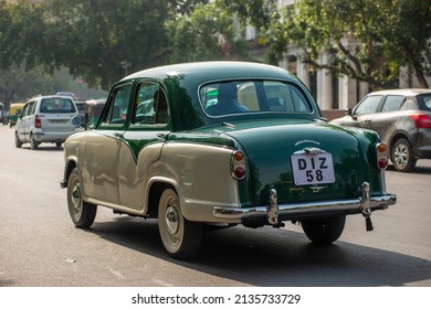 New Delhi, India-March 6 2022: Vintage Ambassador Car On Road Of Connaught Place During Traffic.