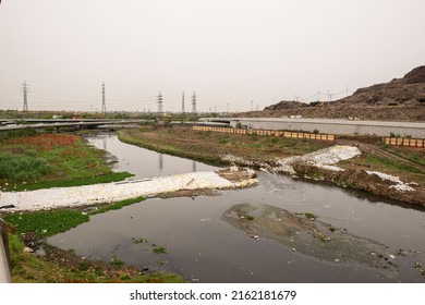 New Delhi, India-May 23 2022: City Drain Near Bhalswa Landfill Site In Delhi, Sandbags For Flood Defense . Sacks With Sand To Prevent A Flood. Dangerous Increase Of Water From Rain Storm