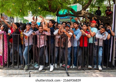 New Delhi, India-May 26 2022: Young Crowd Stand Behind The Iron Barricade In Delhi, Teenagers Crowd In Queue 