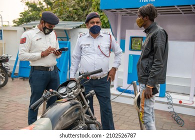 New Delhi, India-Nov 19 2021: Delhi Traffic Police And Government Volunteer Checking Pollution Certificate And Making Challan At Petrol Pump.