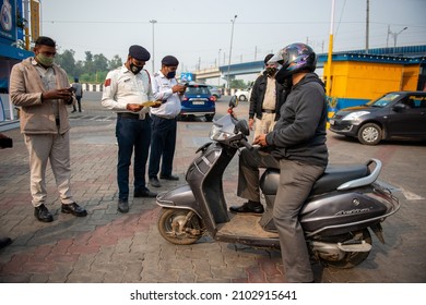 New Delhi, India-Nov 19 2021: Delhi Traffic Police Checking Pollution Certificate And Making Challan Of Two Wheeler Rider At Petrol Pump.