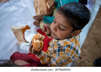 New Delhi, India-Nov 3 2021: Slum Charitable School Children Eating Burger During Celebration Of School Opening After Long Covid Lockdown.