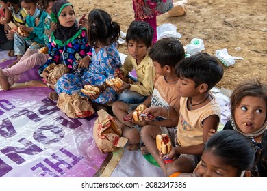 New Delhi, India-Nov 3 2021: Group Of Children Sitting At Charitable School Eating Burger During Celebration Of School Opening After Long Covid Lockdown.