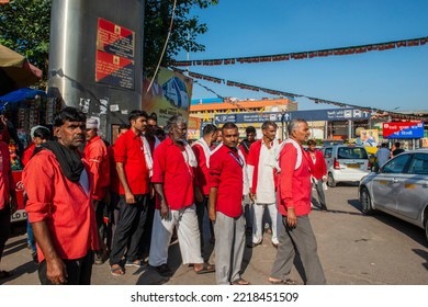 New Delhi, India-Oct 13 2022: Railway Porters In Their Red Uniforms Waiting For Passengers, Porters Role Is The Traditional Luggage Carrying Job At Railway Stations  