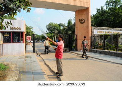 New Delhi, India-sep 1 2019: Gardener Giving Water To Tree By Pipe Near Main Gate Of  The Indira Gandhi National Open University (IGNOU), Central Open Learning University Located At Maidan Garhi