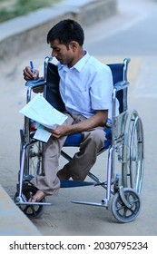 New Delhi, India-Sep 1 2019: Disabled Student Sitting On Wheelchair Filling Admission Form At The Indira Gandhi National Open University (IGNOU), Central Open Learning University Located In Delhi