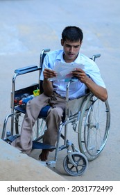 New Delhi, India-Sep 1 2019: Disabled Student Sitting On Wheelchair Filling Admission Form At The Indira Gandhi National Open University (IGNOU), Central Open Learning University Located In Delhi