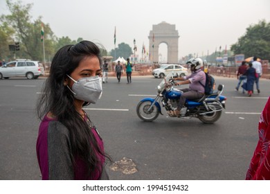 New Delhi, India-September 30 2019: woman in mask visiting india gate during air pollution, famous landmark and the local citizens come to relax with their families and friends.
