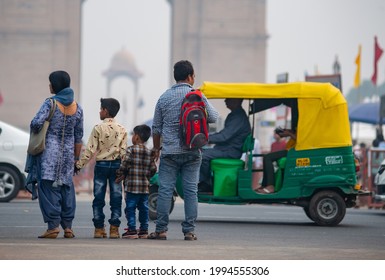 New Delhi, India-September 30 2019: Indian Middle class family crossing road, they come to India Gate to relax with their families and friends in the surrounding green space during holidays.