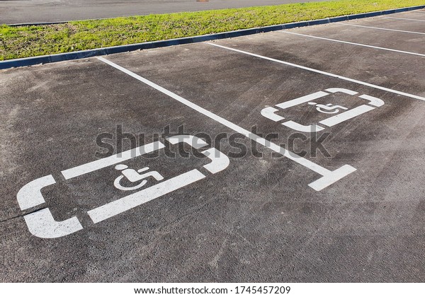 New disabled person sign painted on the new asphalt.
Close up view