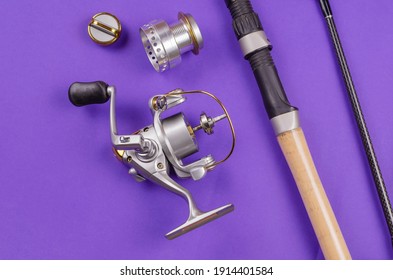 New Disassembled Fly Fishing Reel And Fishing Rod On Blue Background. Metal Bobbin Without Fishing Line. Selective Focus.