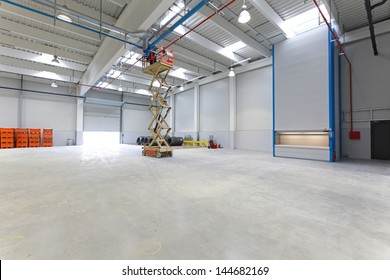 New distribution warehouse hall with hydraulic scissors lift platform