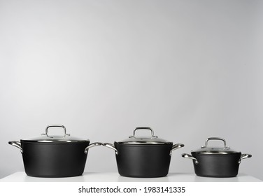 New domestic cookware on grey background close up
