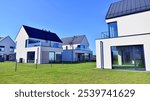 New elegant modern single family house. Terraced family homes in newly developed housing estate. Facade of a modern house with white walls. Real estate concept, european style.  